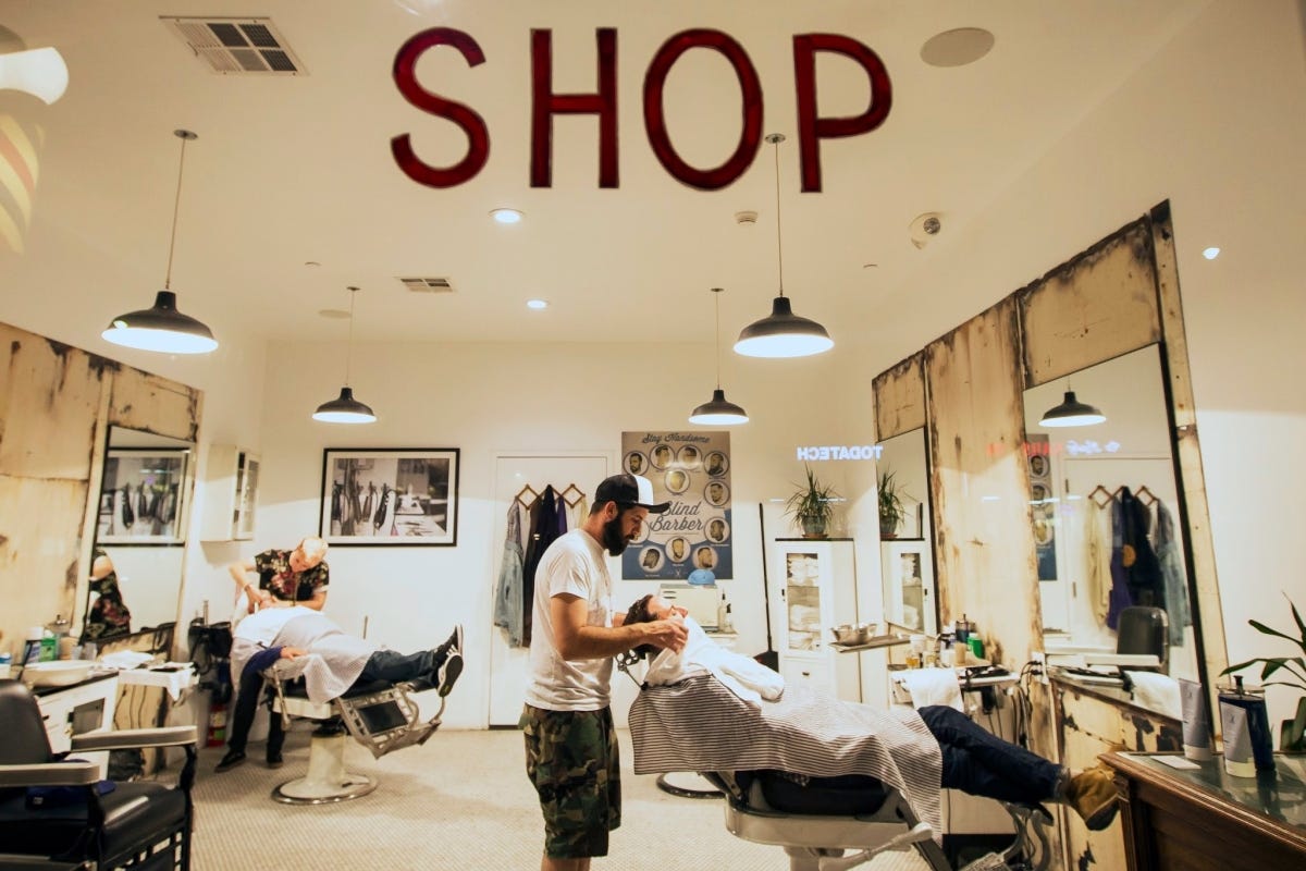 man getting shave at barbershop