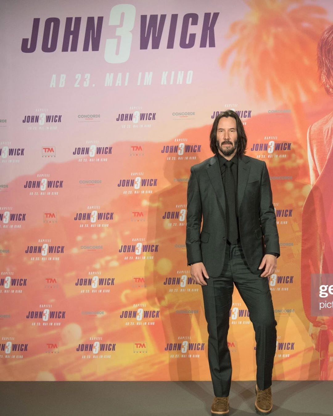 keanu reeves green suit and facial hair