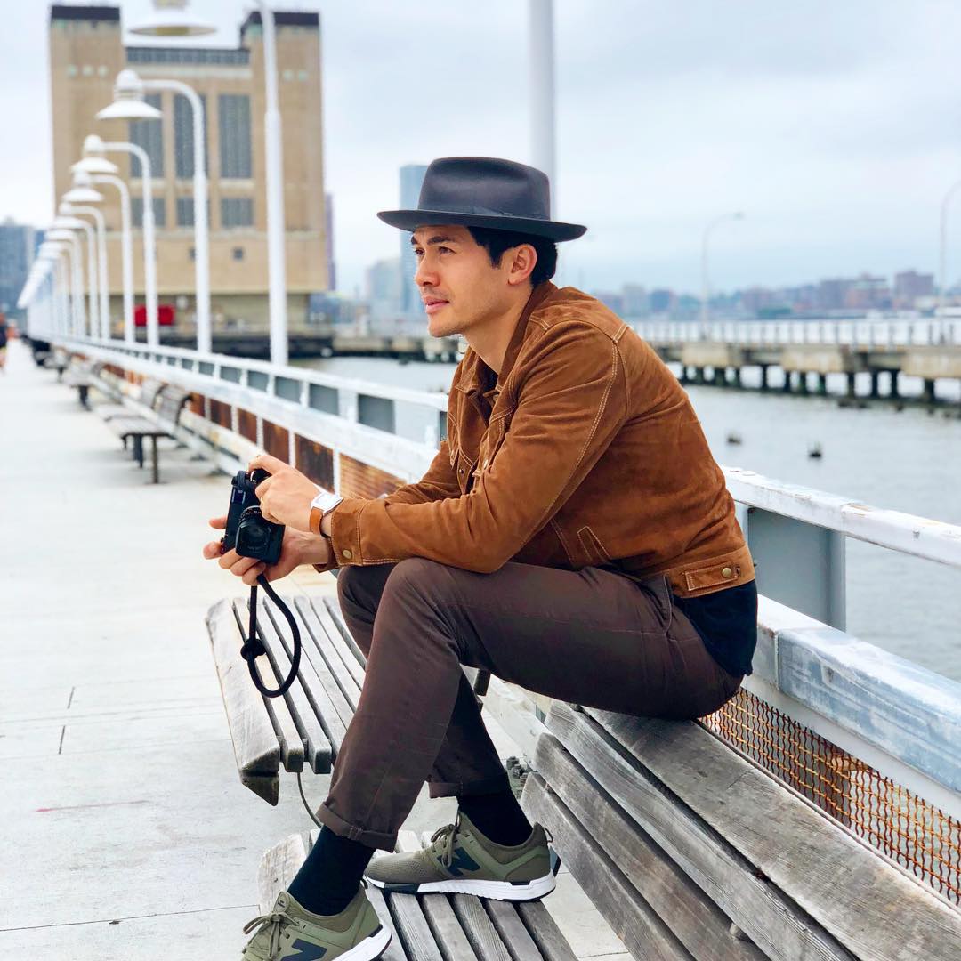 henry golding holding camera