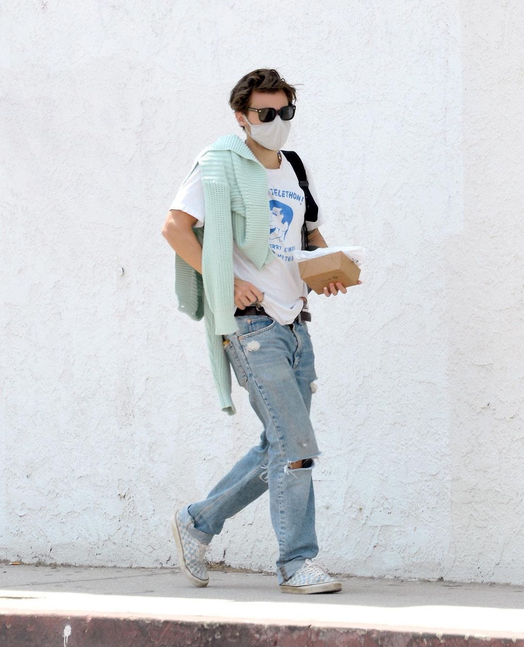 Harry Styles dresses down in scruffy jeans and a hoodie after his