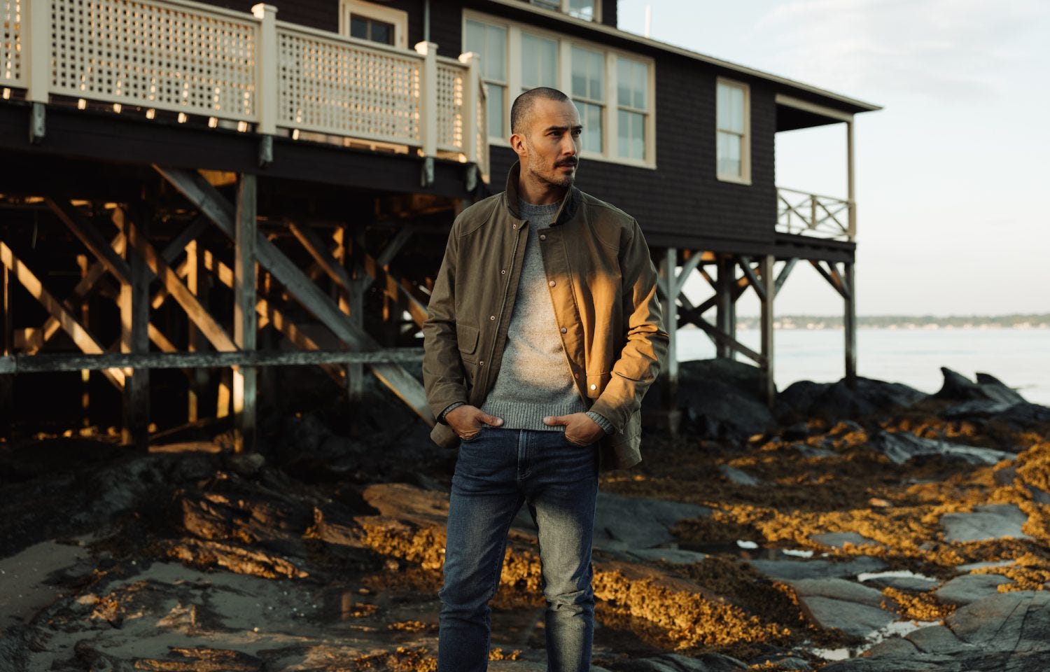 man standing on beach in jacket