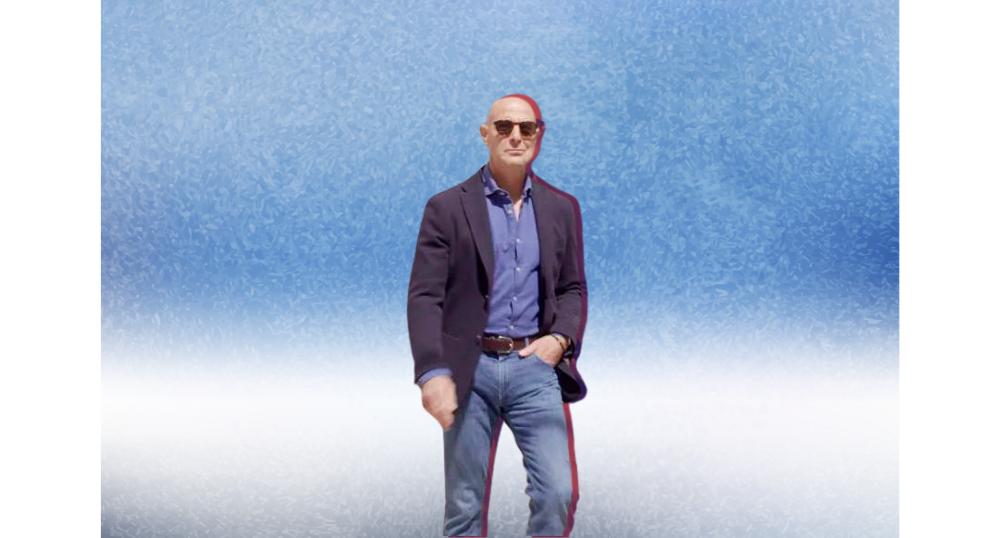 Stanley Tucci in navy blazer and jeans