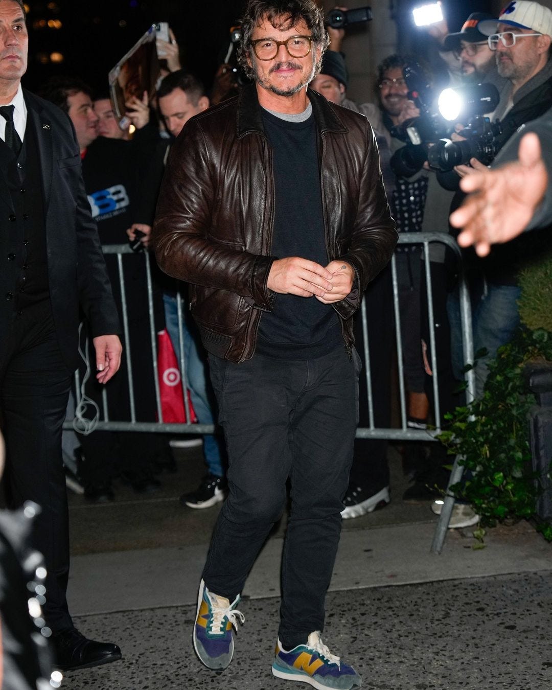 pedro pascal in leather jacket and sneakers