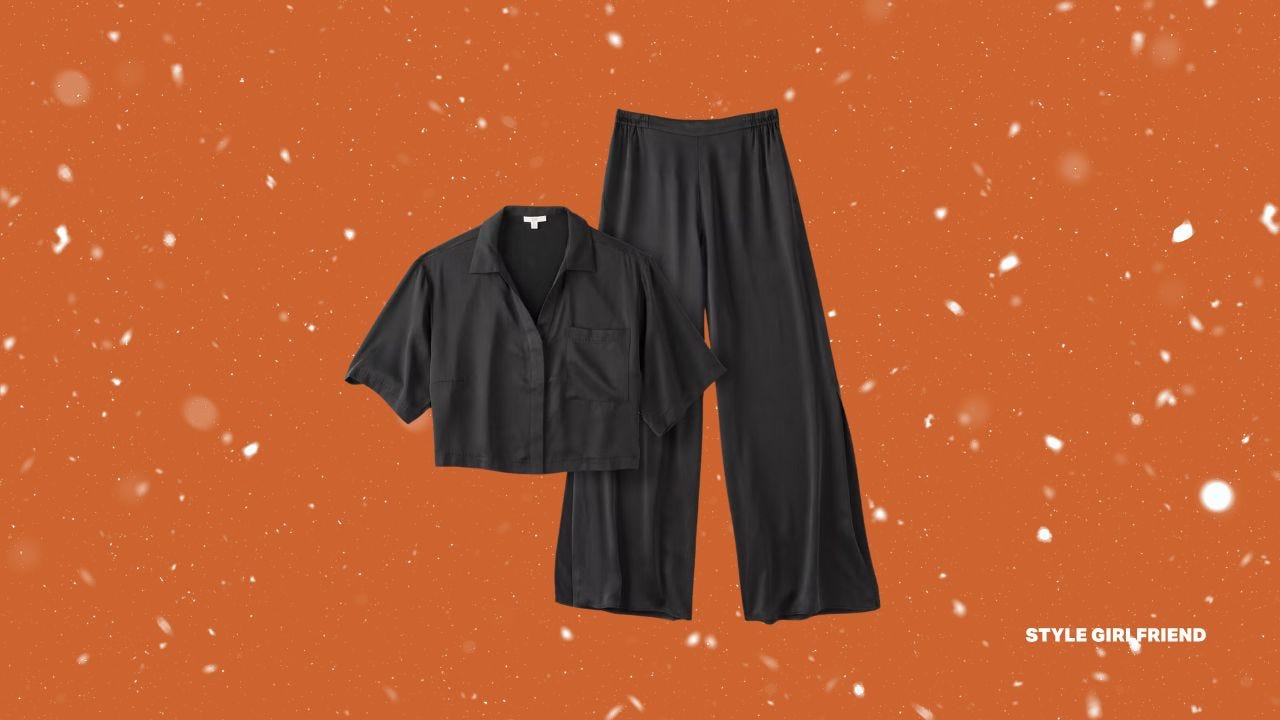 flat lay image of a silky black sleep set featuring a cropped button-up top and long flowy pants