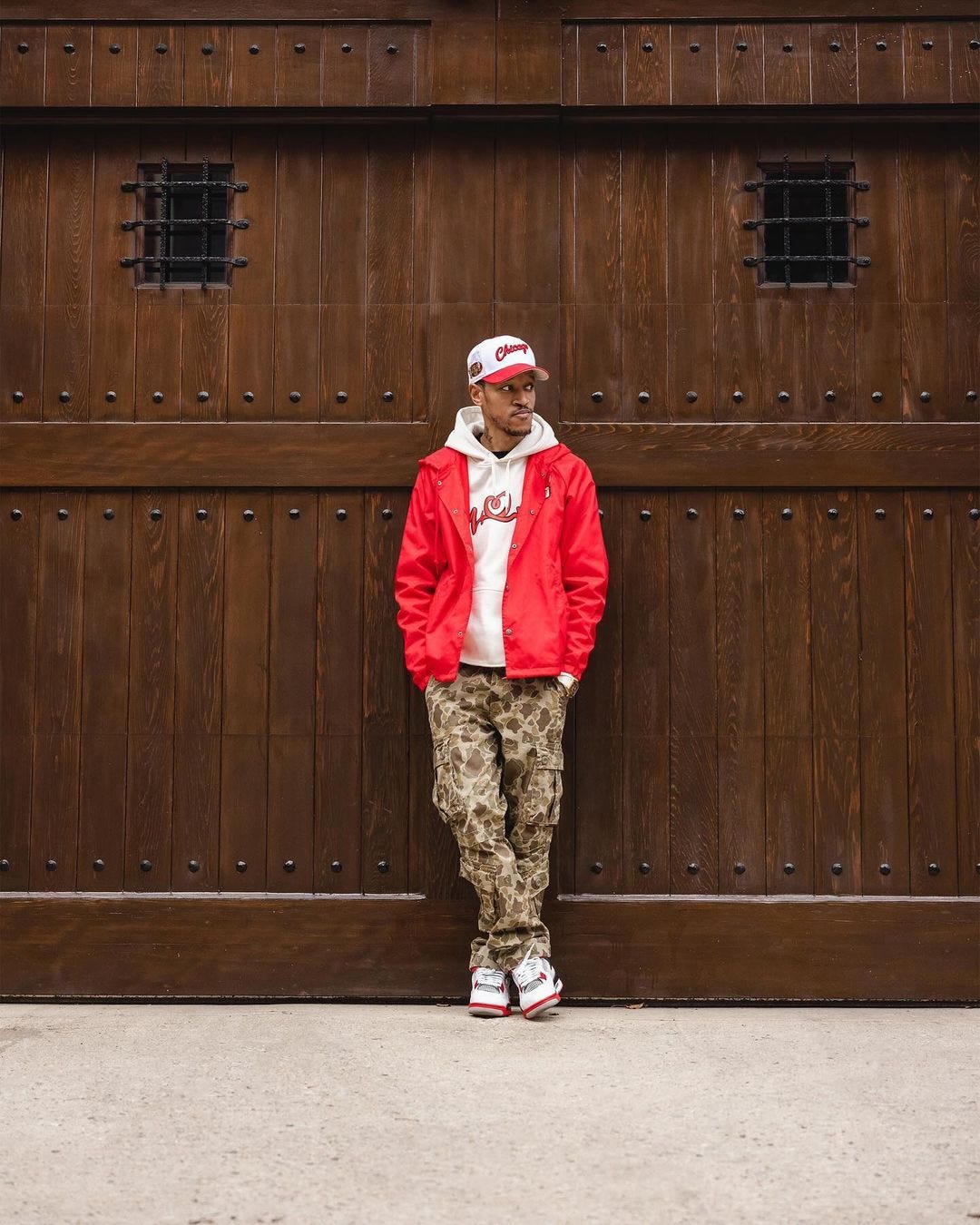 Men's camouflage pants suit with red coach jacket and sneakers