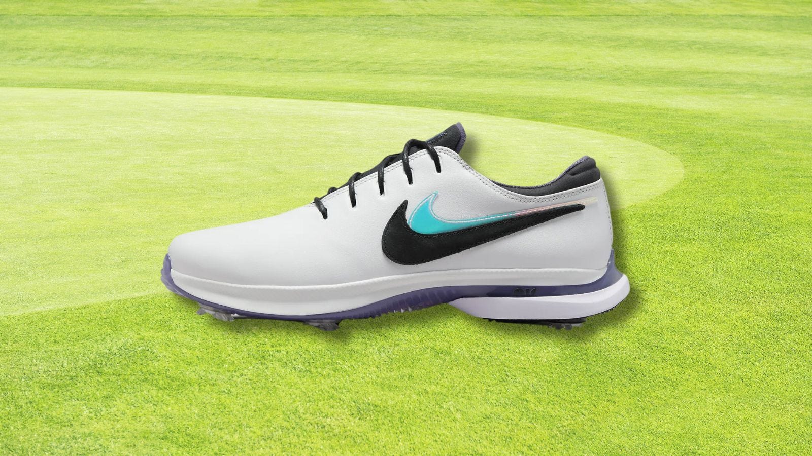picture of nike air zoom victory tour 3 nrg golf shoe set against a golf greens background