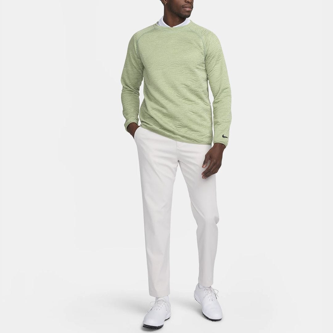 man in light green polo shirt with light chinos and white golf shoes
