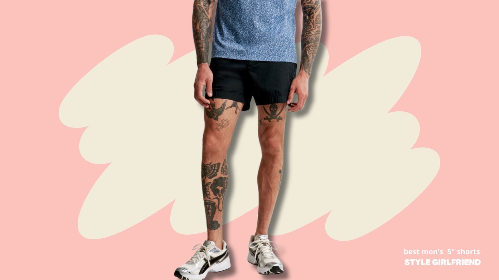 lower half of a man with many tattoos wearing a blue patterned short-sleeve shirt with dark shorts, and white running sneakers