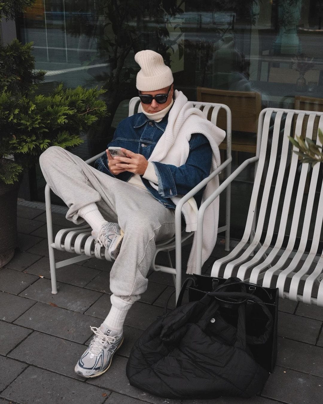 instagram men's style influencer alexxwalther wearing a denim jacket with grey sweatpants