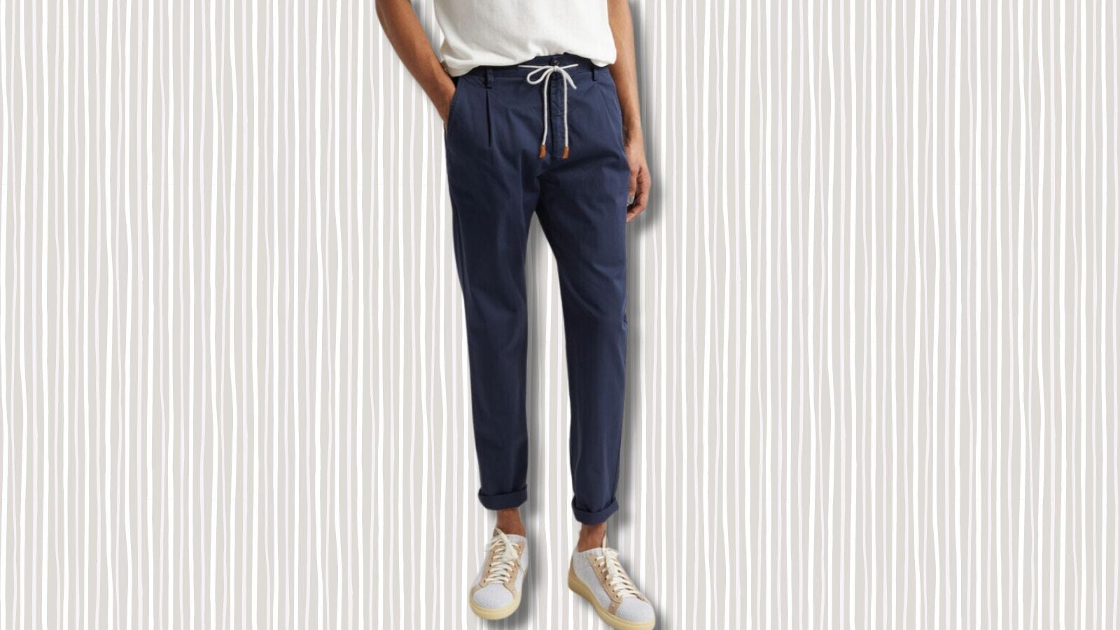 image of a man from the waist down in navy drawstring pants and sneakers