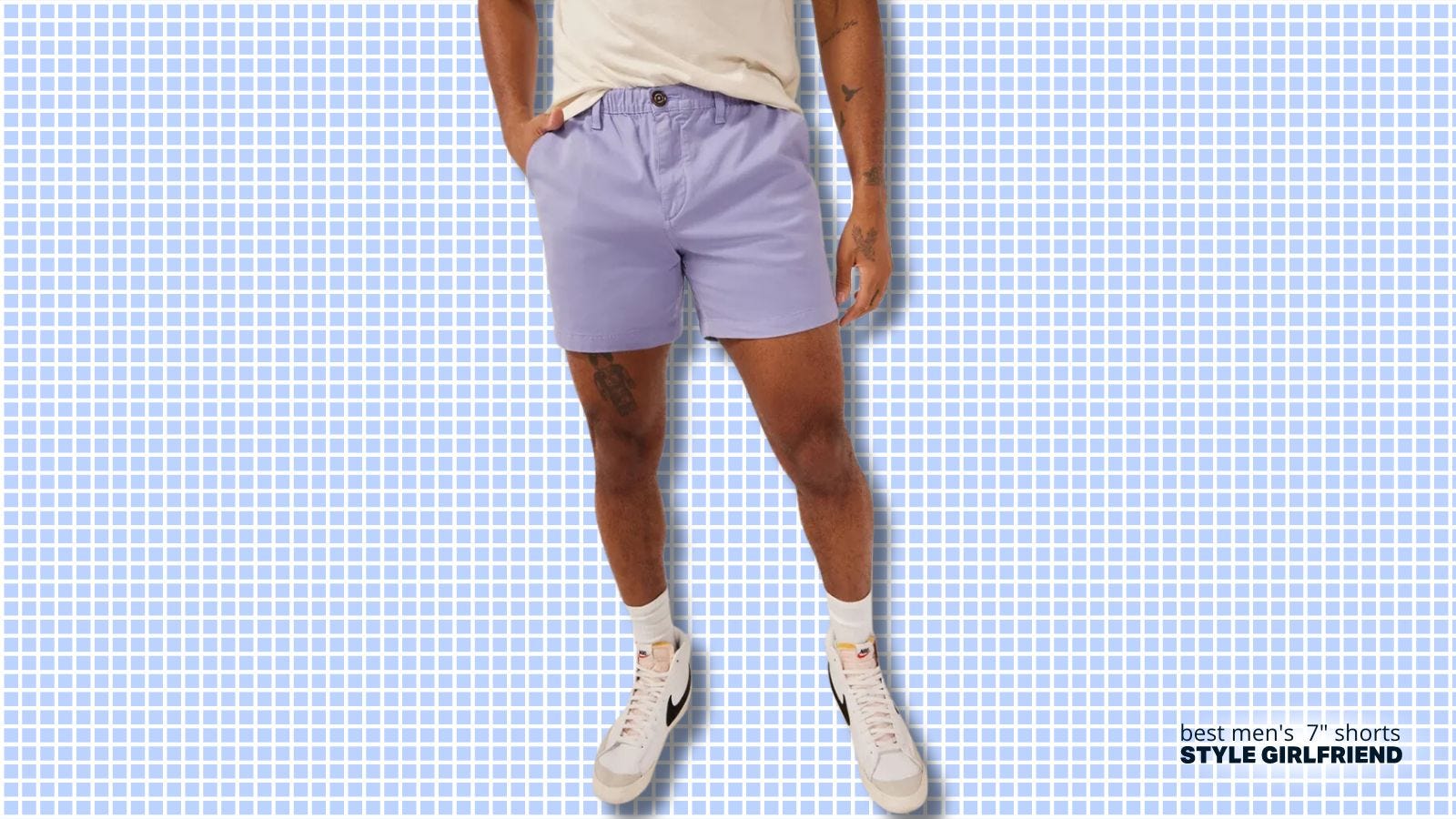 lower half of man wearing cream-colored t-shirt, lavender shorts, with high top nike sneakers 