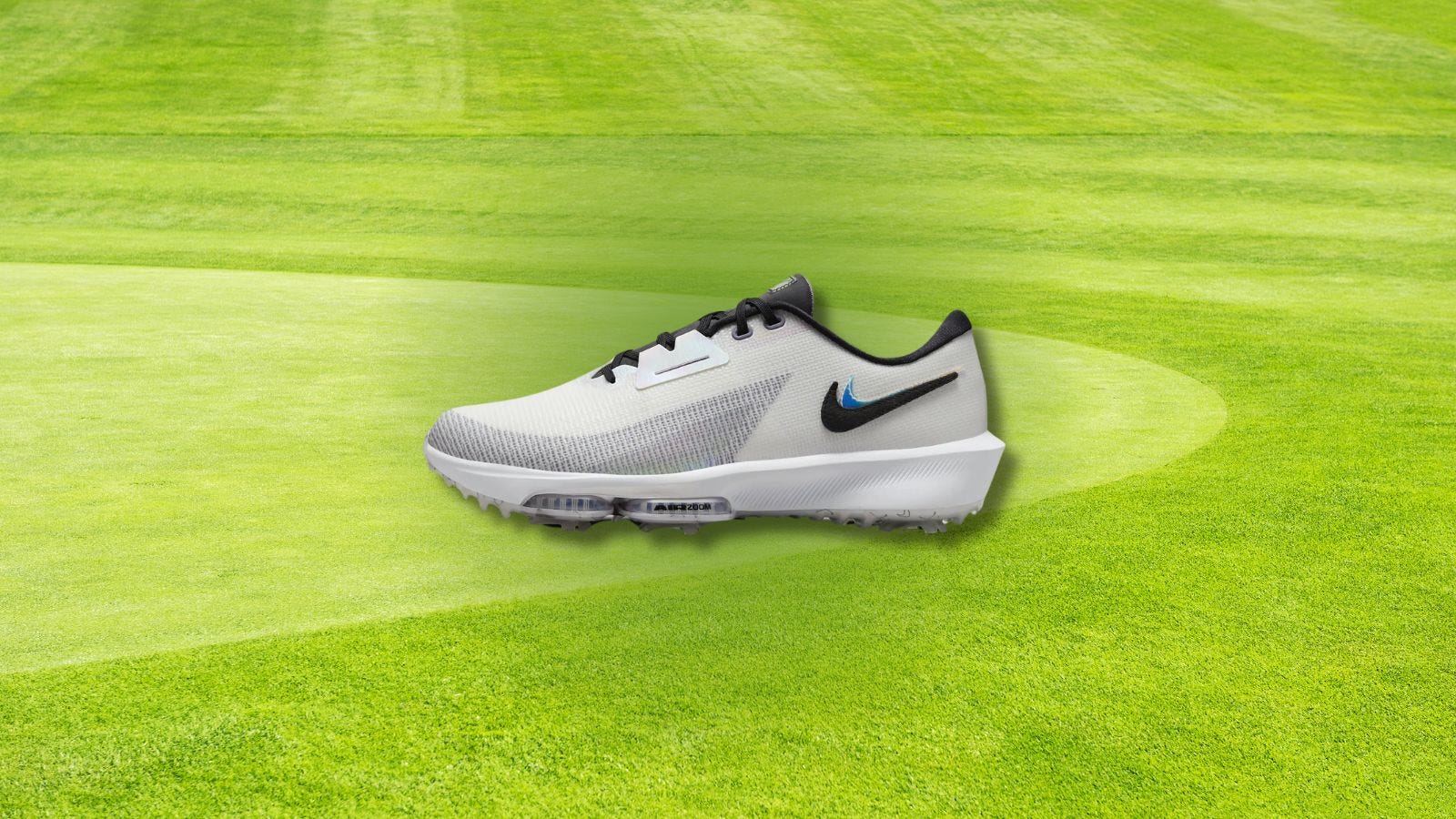 men's nike golf shoe set against a background of a golf green