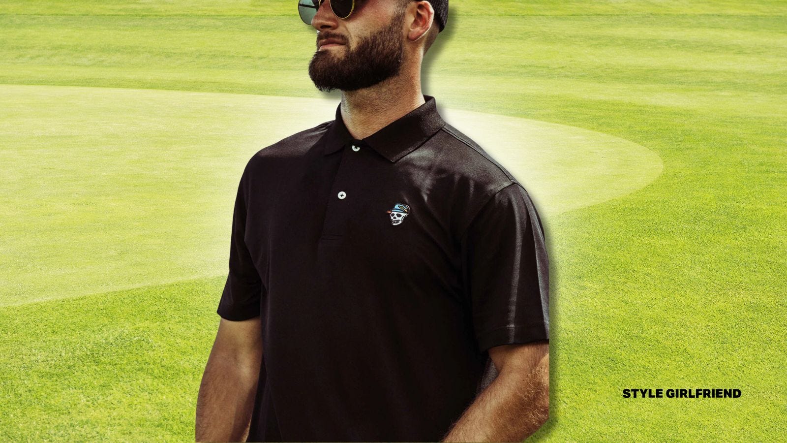 close-up of man's torso, wearing a black golf polo shirt with a small skull logo on the chest