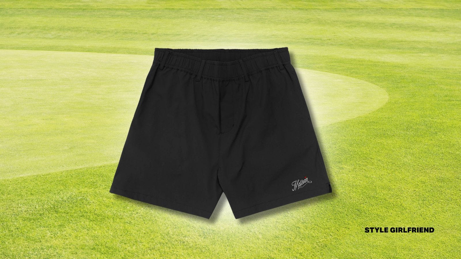 black Malbon golf shorts set against a golf green background