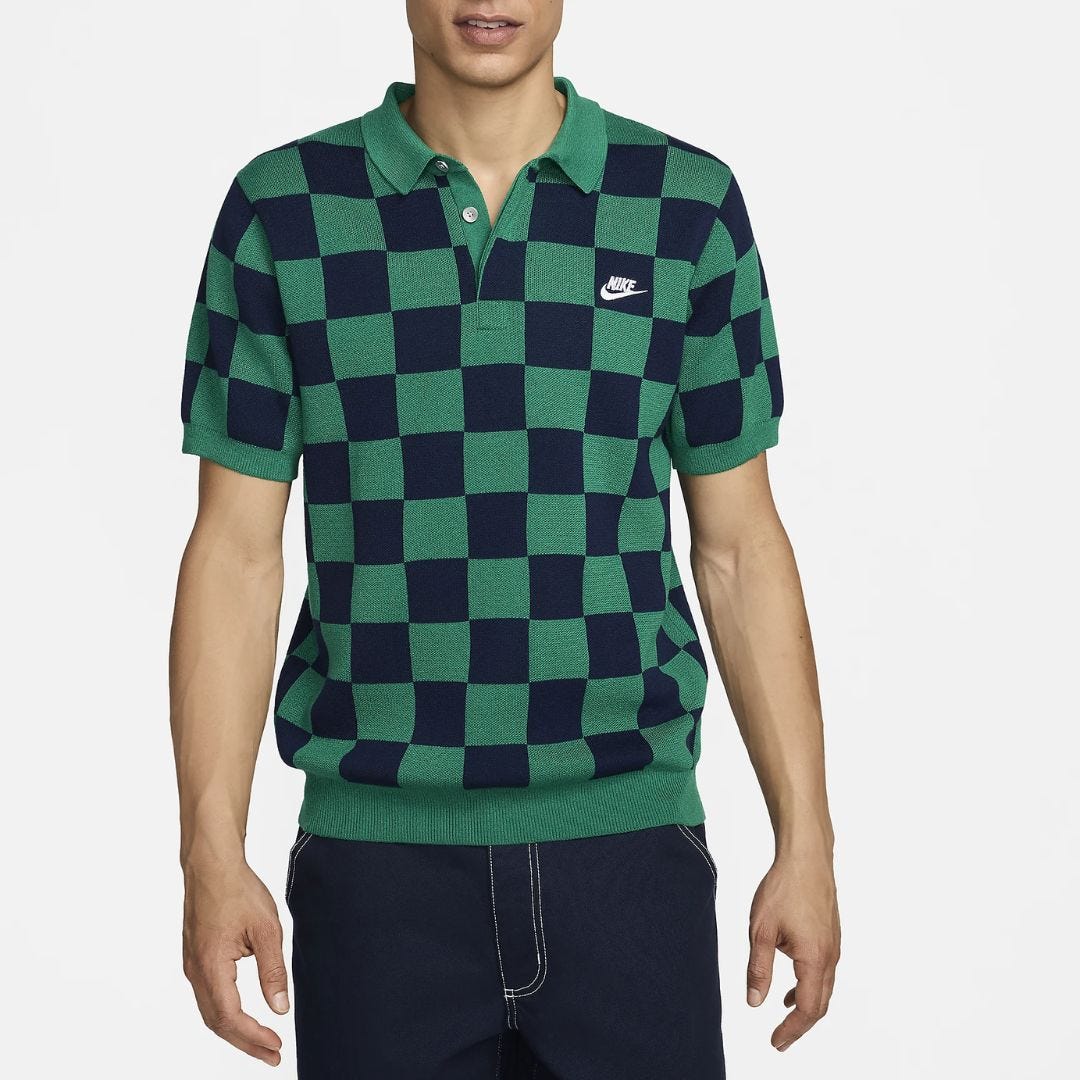 torso of a man wearing a navy and green checkered polo shirt