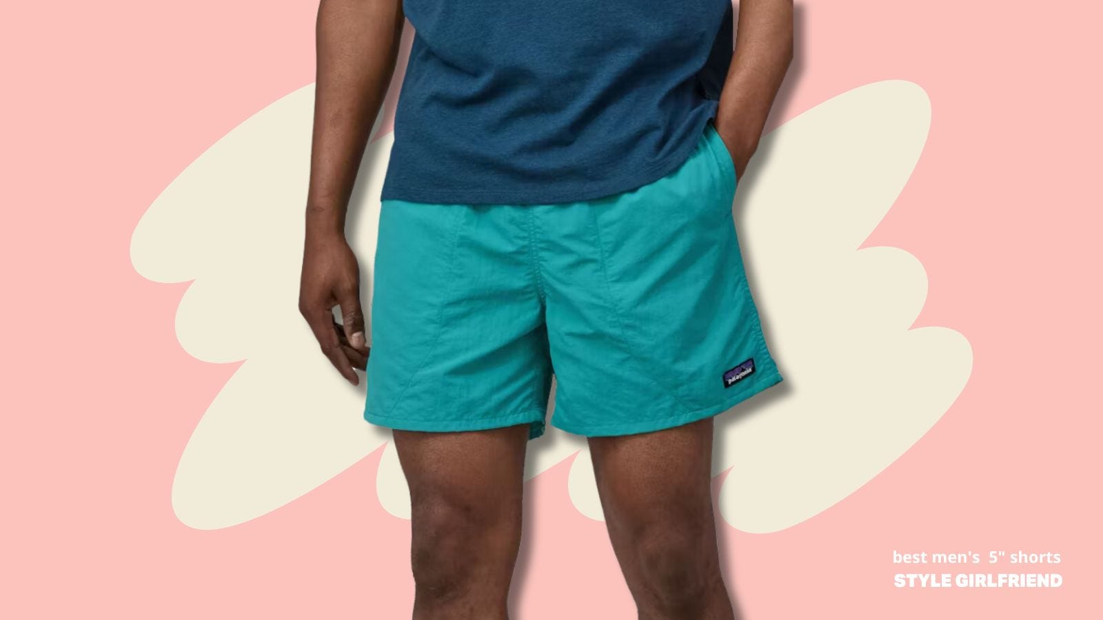 close-up image of a man's torso and upper legs, wearing a blue t-shirt and turquoise nylon shorts 