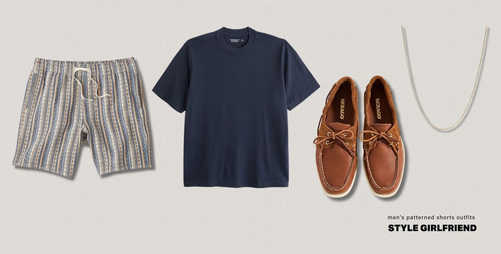 flat lay of men's warm weather outfit including patterned shorts, a navy t-shirt, boat shoes and a chain necklace