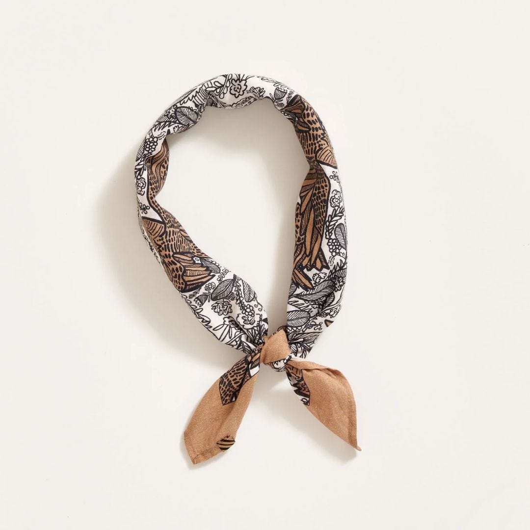close-up of a brown and white patterned bandana tied in a knot