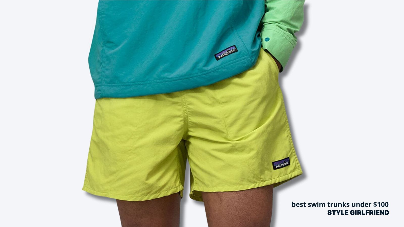 close-up of fluorescent yellow men's swim trunks, paired with a patagonia green fleece. text on-screen reads: best swim trunks under $100, style girlfriend