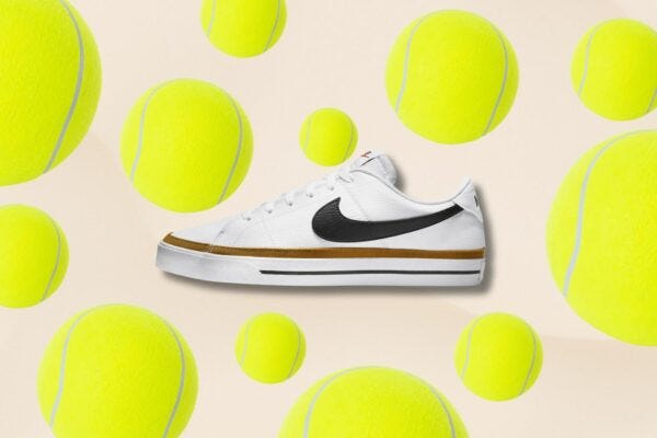 image of a men's Nike tennis sneaker against a background of tennis ball in assorted sizes