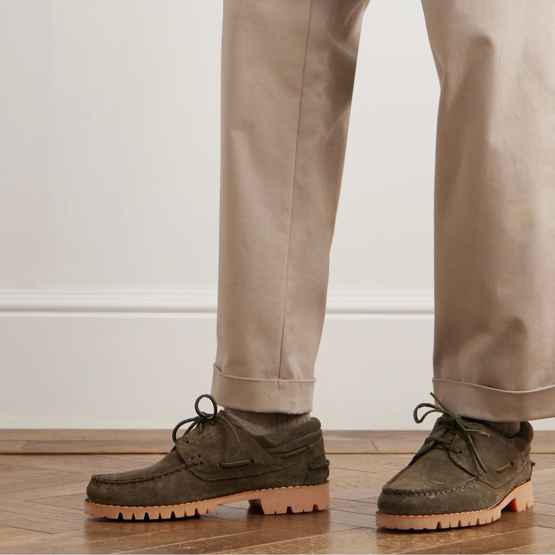Image of a man wearing tan chinos from the knees down and lug-soled boat shoes