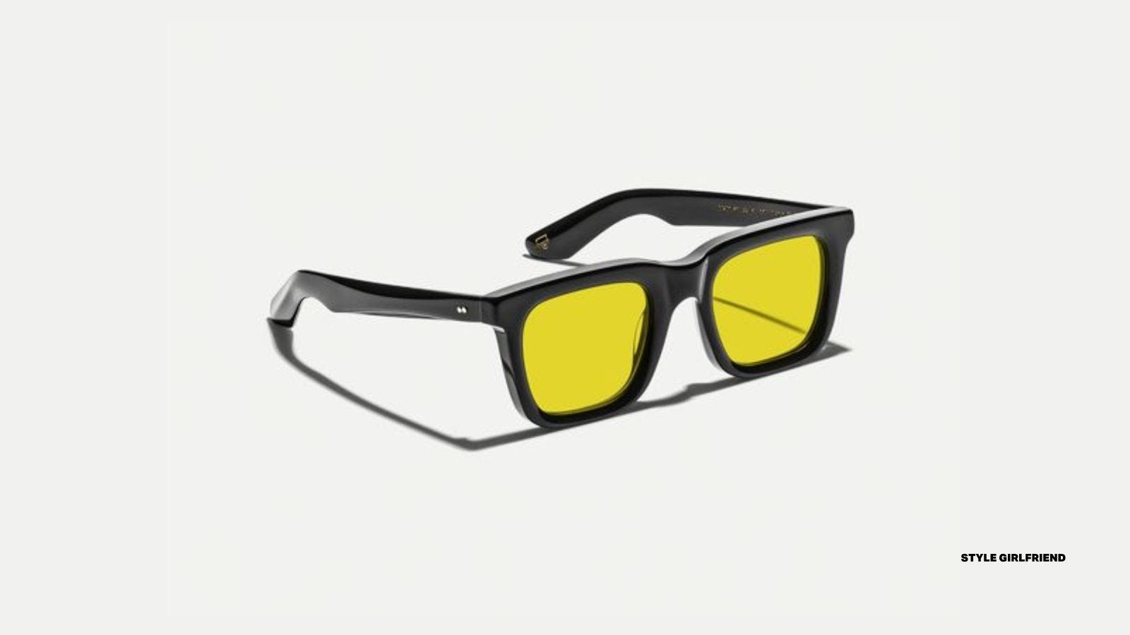 pair of moscot yellow lens sunglasses with black frames