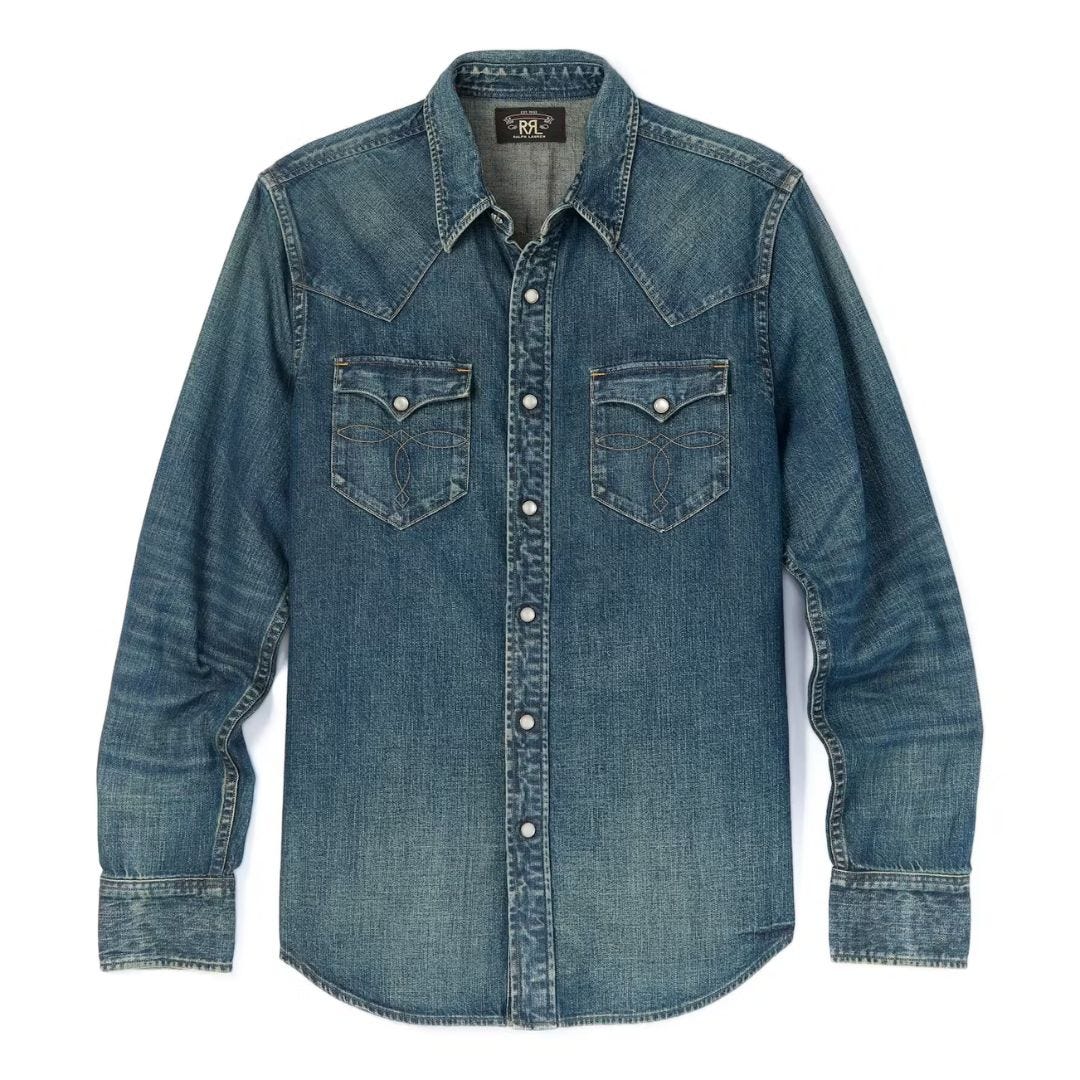 flat lay image of a dark blue denim shirt with snap buttons