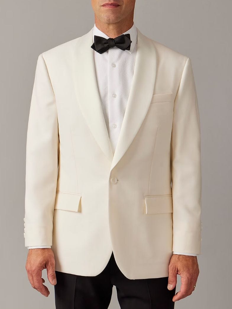 up close image of a men's cream-colored shawl collar tuxedo jacket