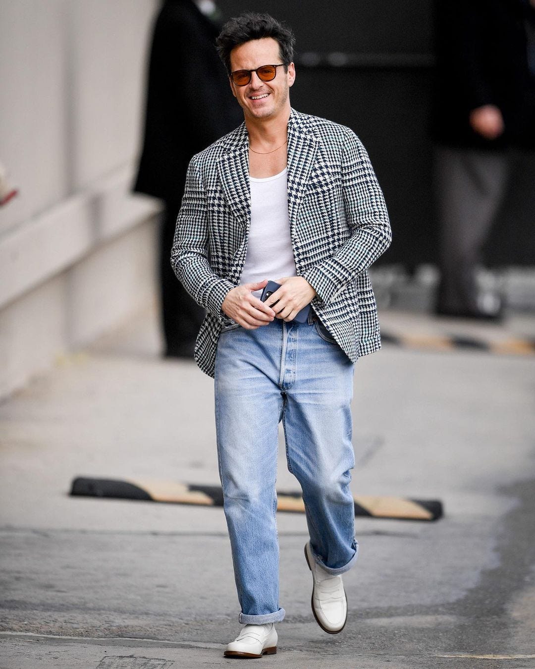 actor Andrew Scott wearing a blazer and jeans, smiling at the camera