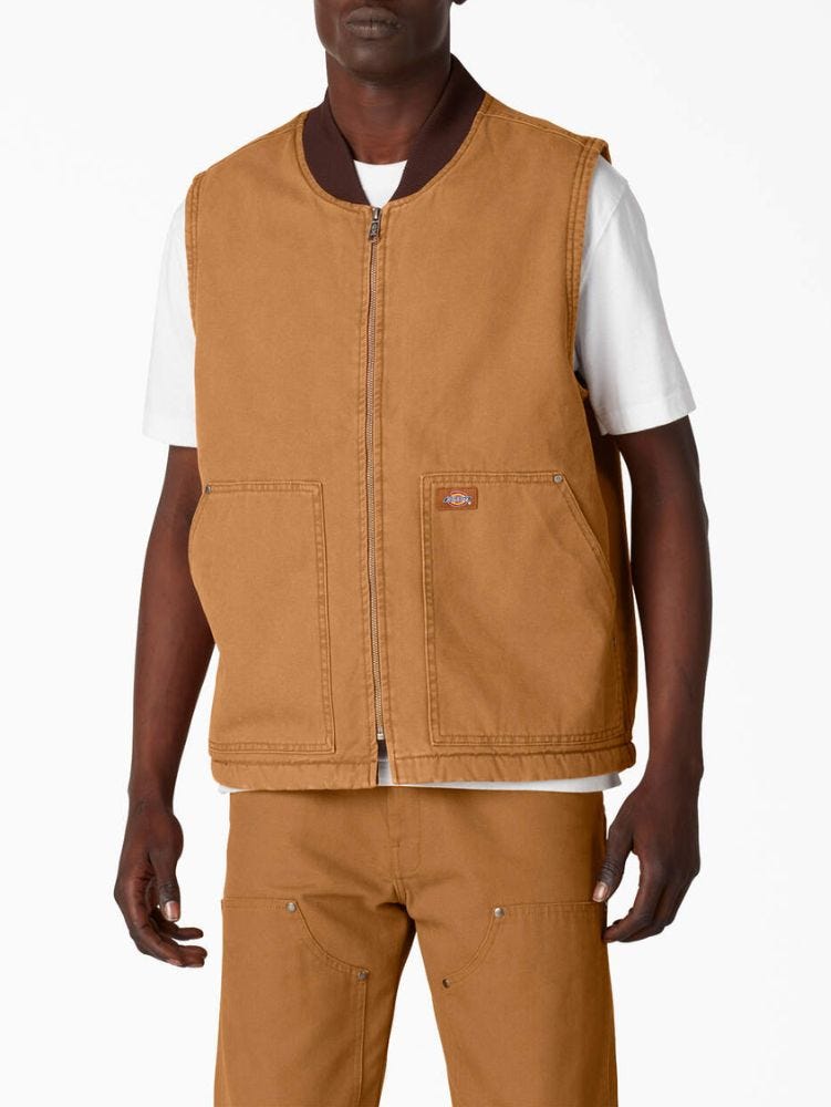 man from the neck down wearing a brown dickies zip-up sleeveless vest