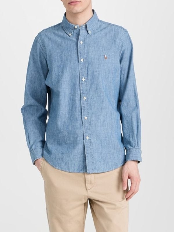 man from the waist up wearing chinos and a blue chambray shirt