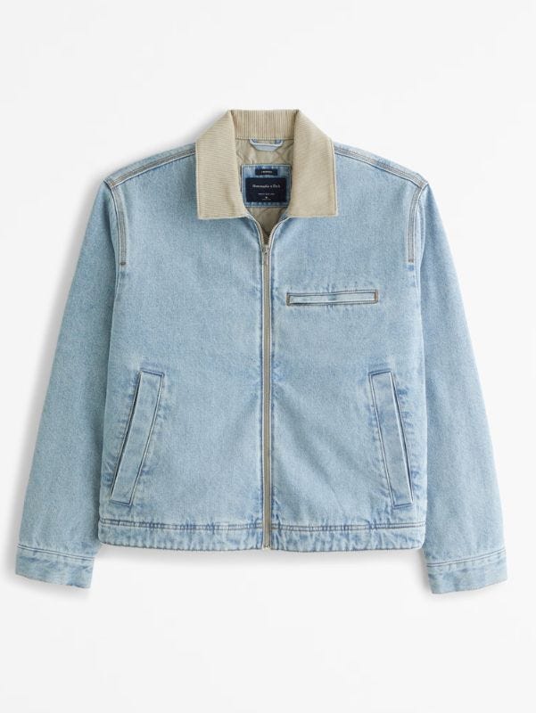 flat lay image of a men's light denim workwear jacket with a corduroy collar