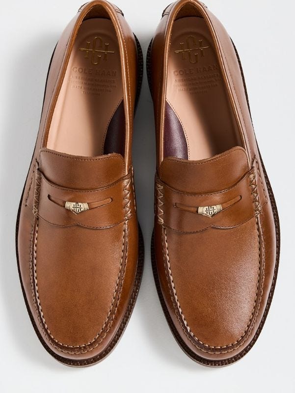 close-up of brown leather penny loafers with pennies in them