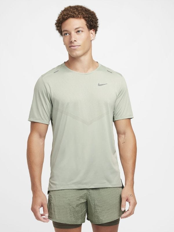 Man wearing light green running shirt and green running shorts above the knees