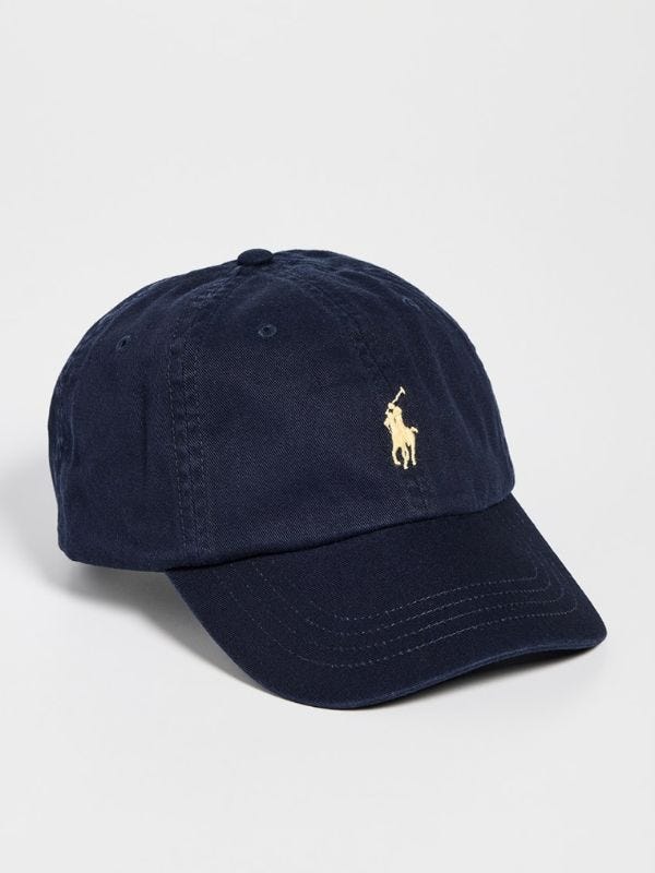 navy baseball cap with gold embroidery of a polo player