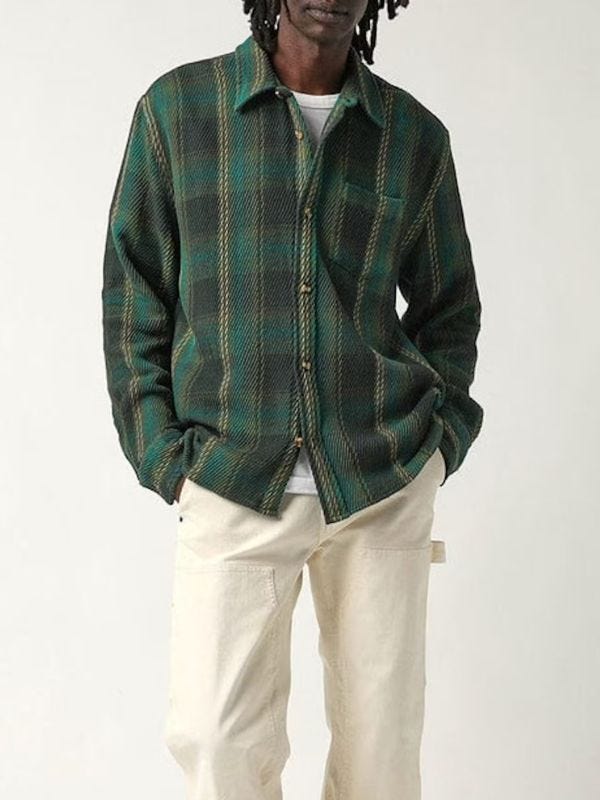 man wearing green plaid shirt and cream-colored double-knee work pants