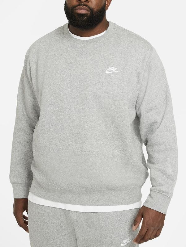 Close-up of a man wearing a gray Nike crew-neck sweatshirt