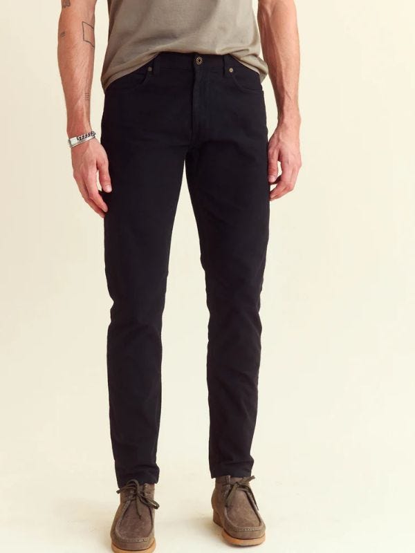 man from the waist down wearing black moleskin jeans with wallabee boots