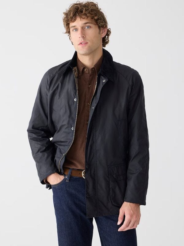 man wearing a navy waxed jacket