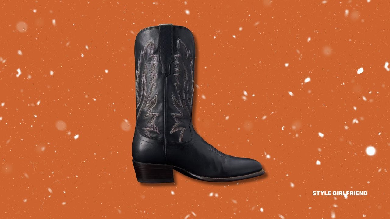 single black cowboy boot against a rust-colored background