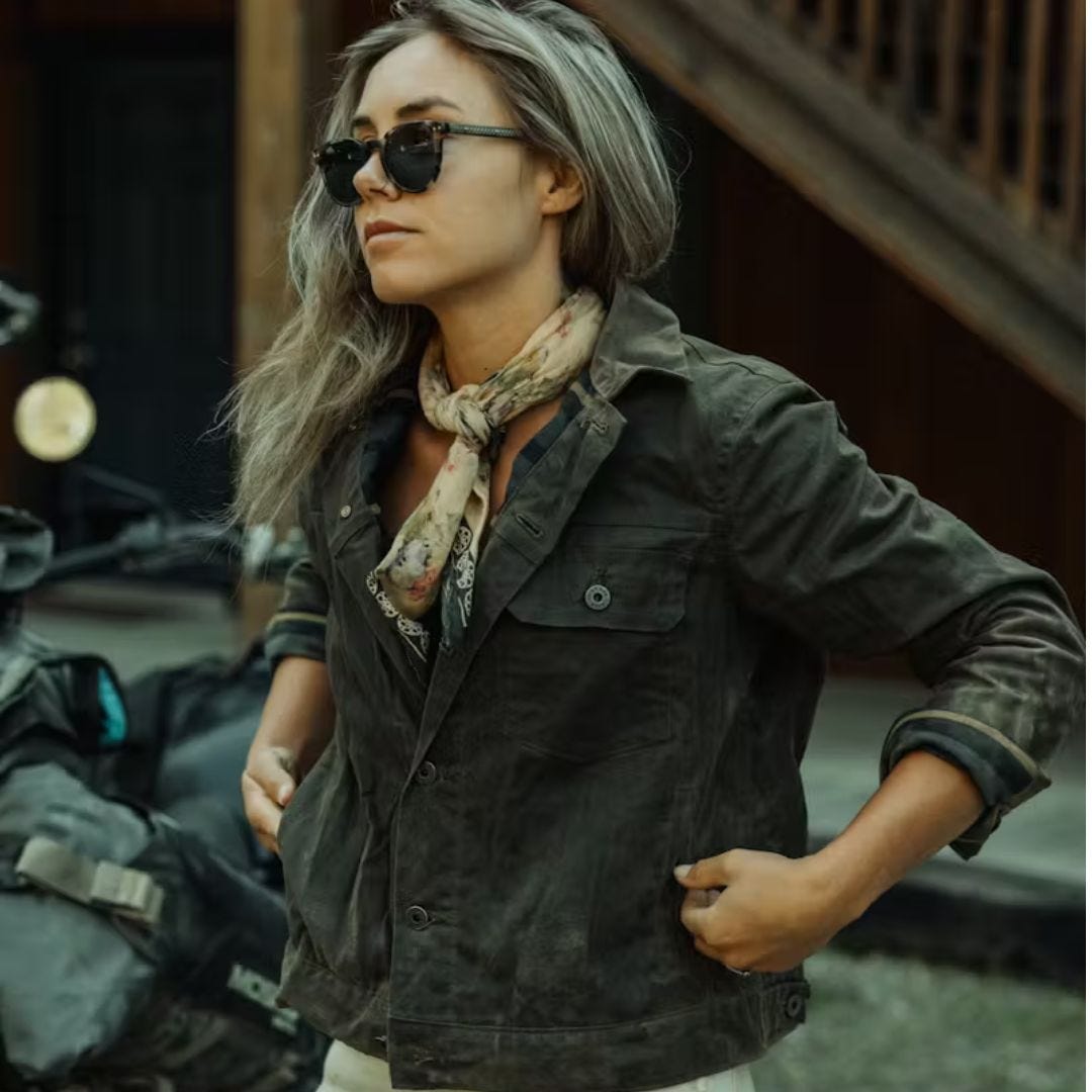 blonde woman wearing a dark green waxed trucker jacket included in a roundup of huckberry gifts for her