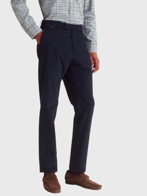 man from the waist down wearing navy corduroy trousers