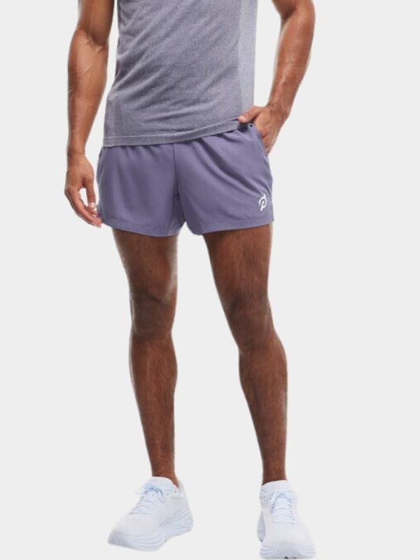 fit man from the waist down wearing lavender workout shorts and white sneakers