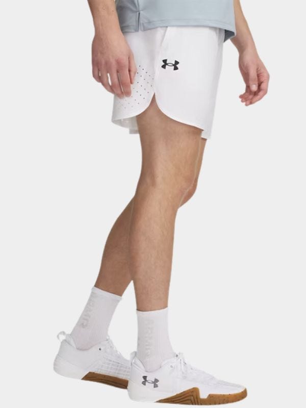 profile image of a man from the waist down wearing white athletic shorts, tall white socks and white sneakers