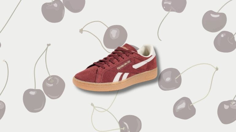 reebok club c sneakers set against a background of black cherries