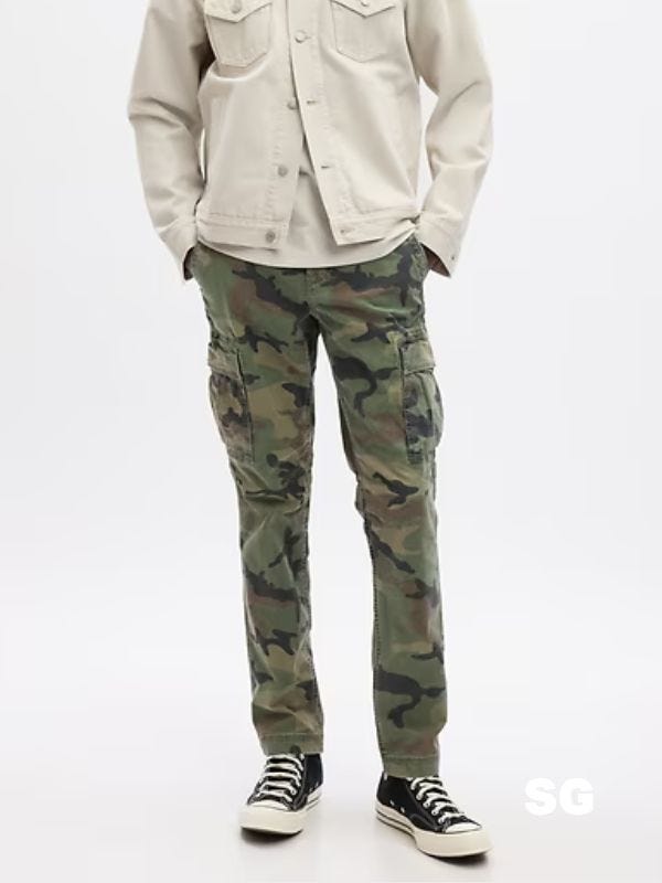 man from the waist down wearing camo cargo pants with black lace-up  high top sneakers