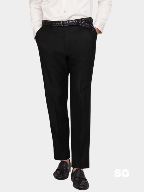 man from the waist down wearing black dress pants, a black braided leather belt, and black loafers