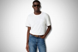 stylish man wearing a white pocket t-shirt, jeans, a leather belt and black sunglasses