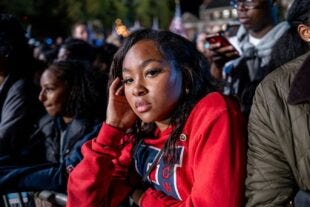 disappointed woman wearing red sweatshirt looking at camera