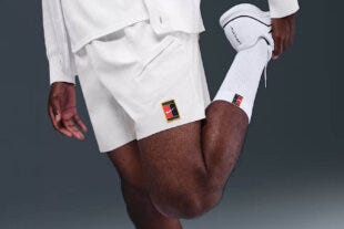 close-up of a man wearing white nike tennis shorts
